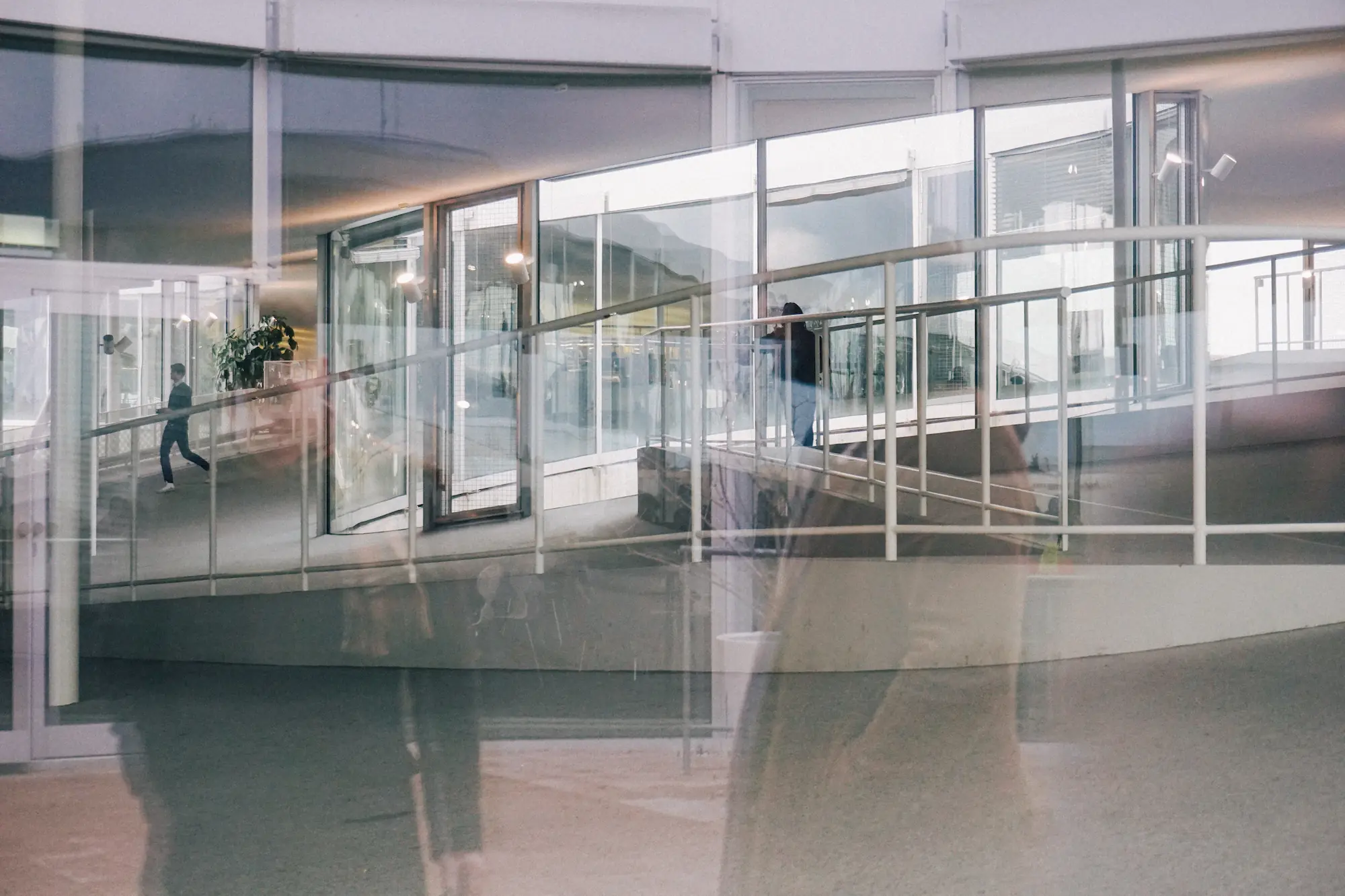 Interior of the Rolex Learning Center by SANAA, Lausanne, Switzerland, 2010 — continuous curved surfaces and glass facades dissolving spatial boundaries. Photograph by Mete Kutlu, 2015