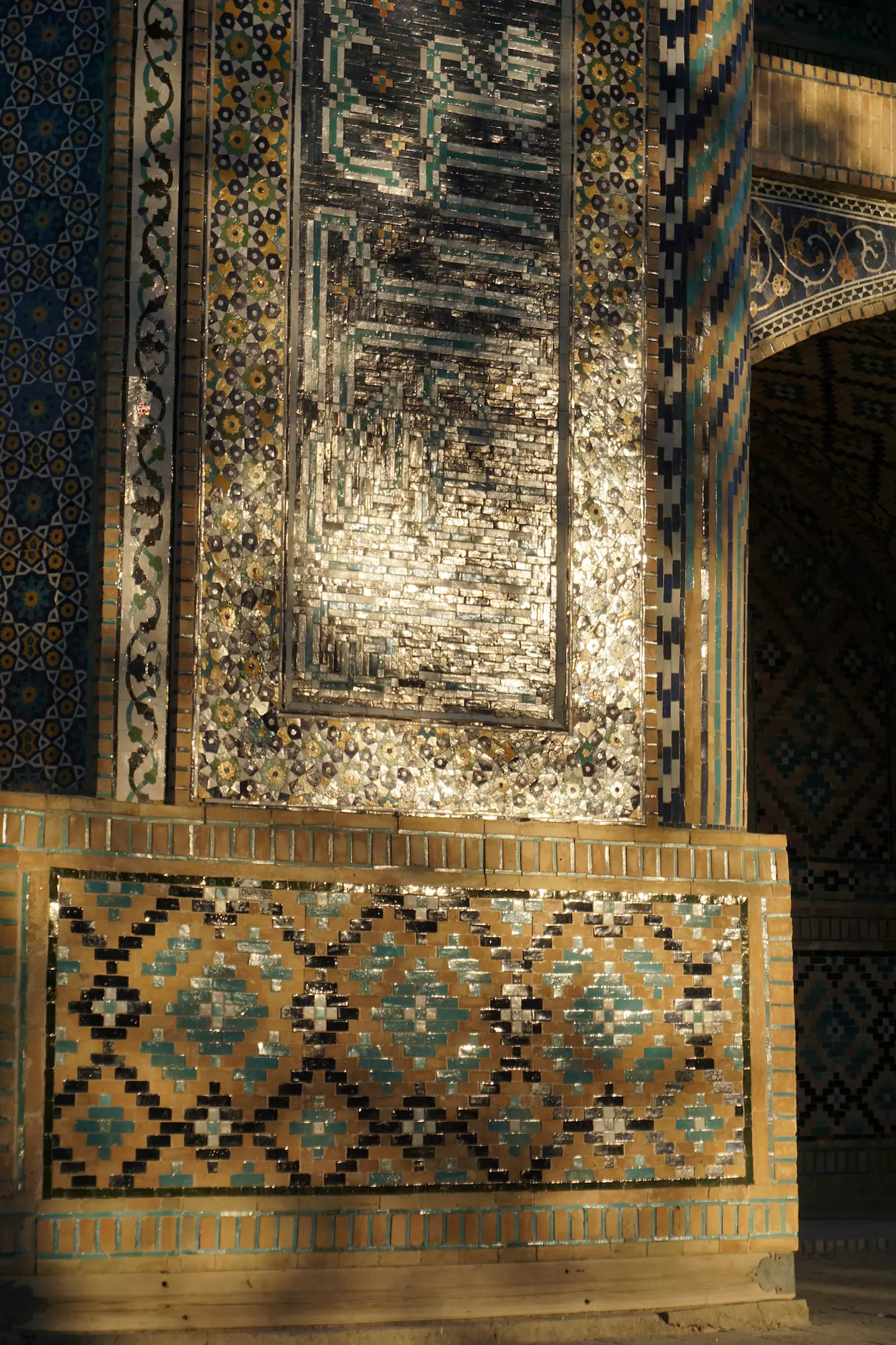 Glazed quartz mosaic tilework on the facade of the Nadir Divanbegi Madrasa, Bukhara, Uzbekistan, 1623 — cobalt blue reflective surface from silica-rich tesserae. Photograph by Mete Kutlu, 2021